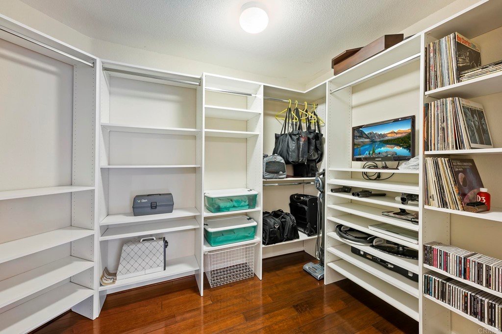 7057 Eider Court Carlsbad, CA 92011 - Photo 31 of 65 a view of walk in closet with clothes and shoes