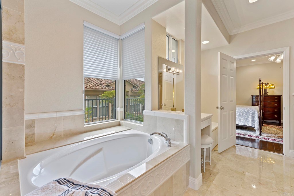 7057 Eider Court Carlsbad, CA 92011 - Photo 34 of 65 a spacious bathroom with a tub and large window