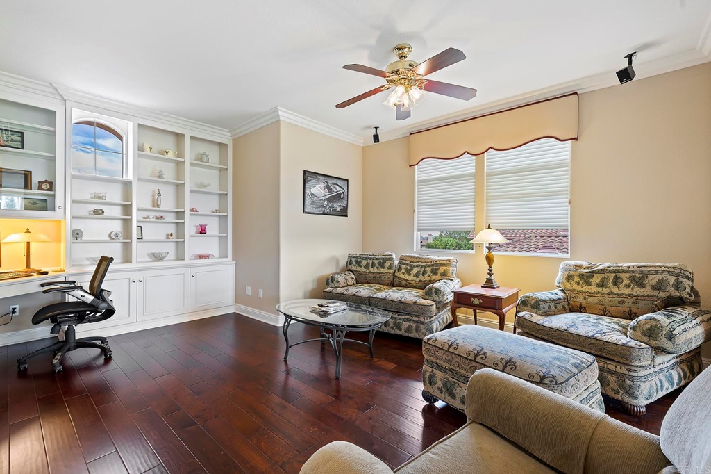 7057 Eider Court Carlsbad, CA 92011 - Photo 38 of 65 a living room with furniture window and wooden floor