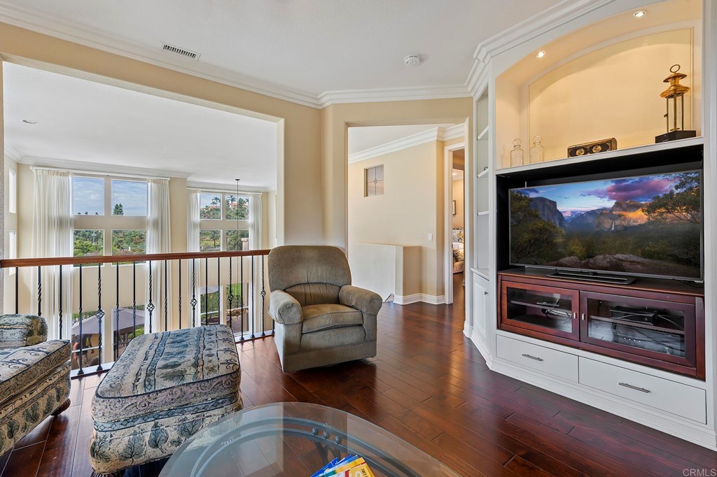 7057 Eider Court Carlsbad, CA 92011 - Photo 41 of 65 a living room with furniture and a flat screen tv