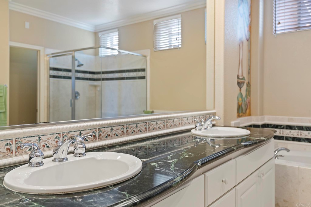7057 Eider Court Carlsbad, CA 92011 - Photo 49 of 65 a bathroom with a sink and a mirror