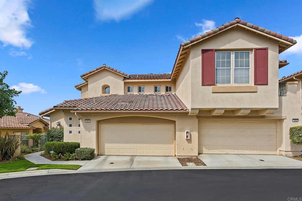 7057 Eider Court Carlsbad, CA 92011 - Photo 6 of 65 a front view of a house with a yard and garage