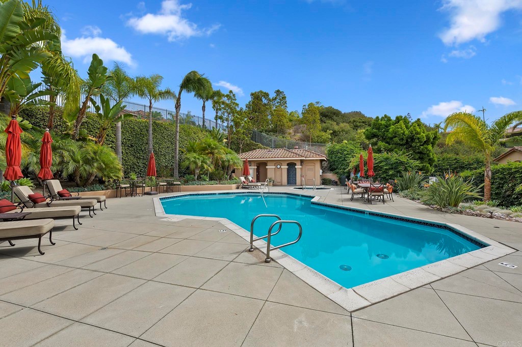 7057 Eider Court Carlsbad, CA 92011 - Photo 62 of 65 a view of swimming pool with outdoor seating and yard in back