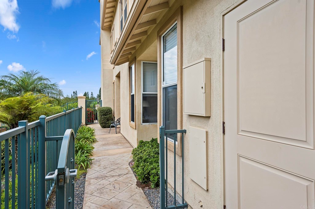 7057 Eider Court Carlsbad, CA 92011 - Photo 9 of 65 a view of a pathway of a house with wooden fence