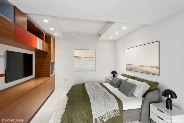 a bedroom with a bed and a flat screen tv