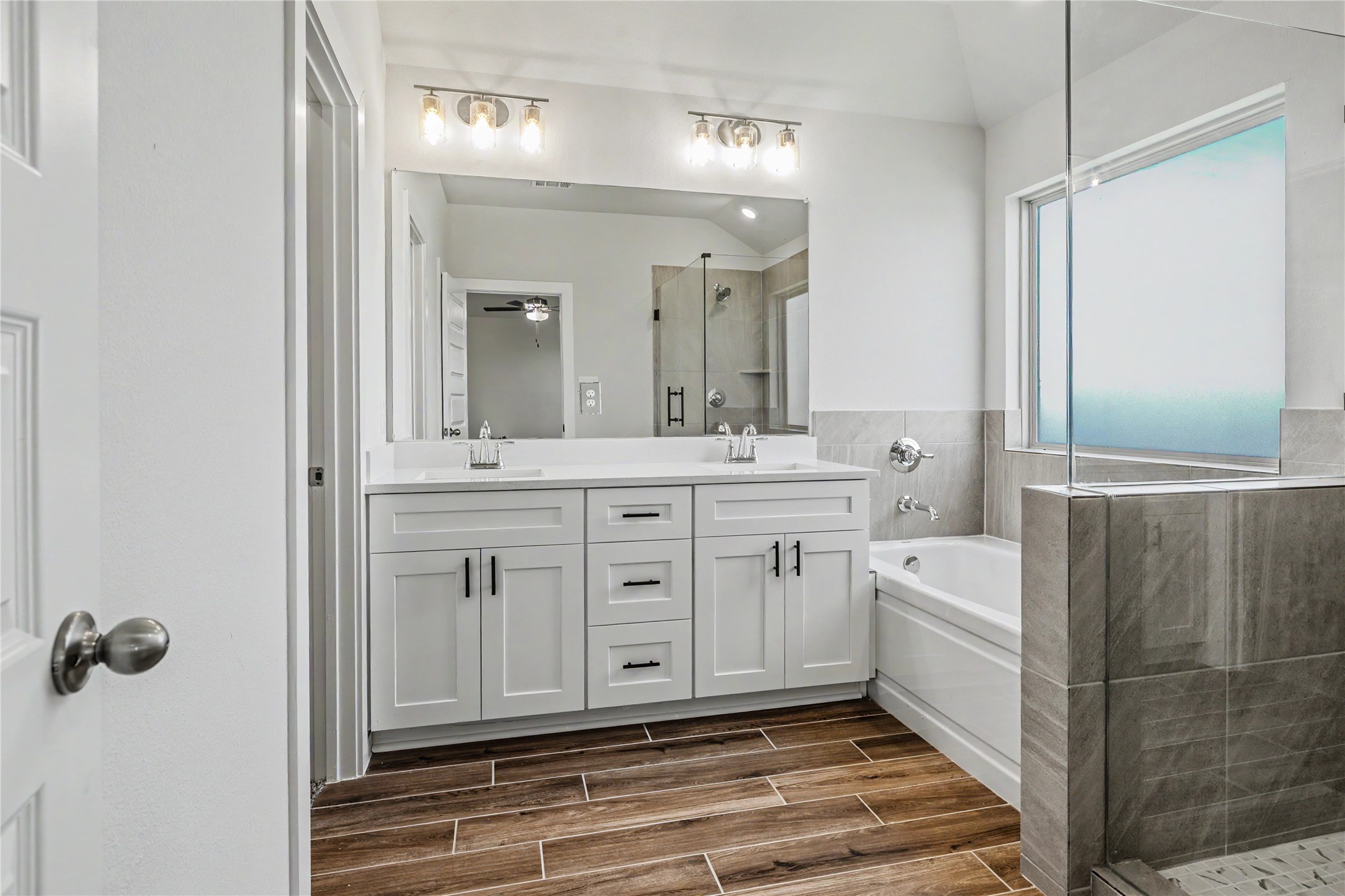6427 Bolinas Court Rosharon, TX 77583 - Photo 26 of 49 a spacious bathroom with a double vanity sink a mirror and a bathtub