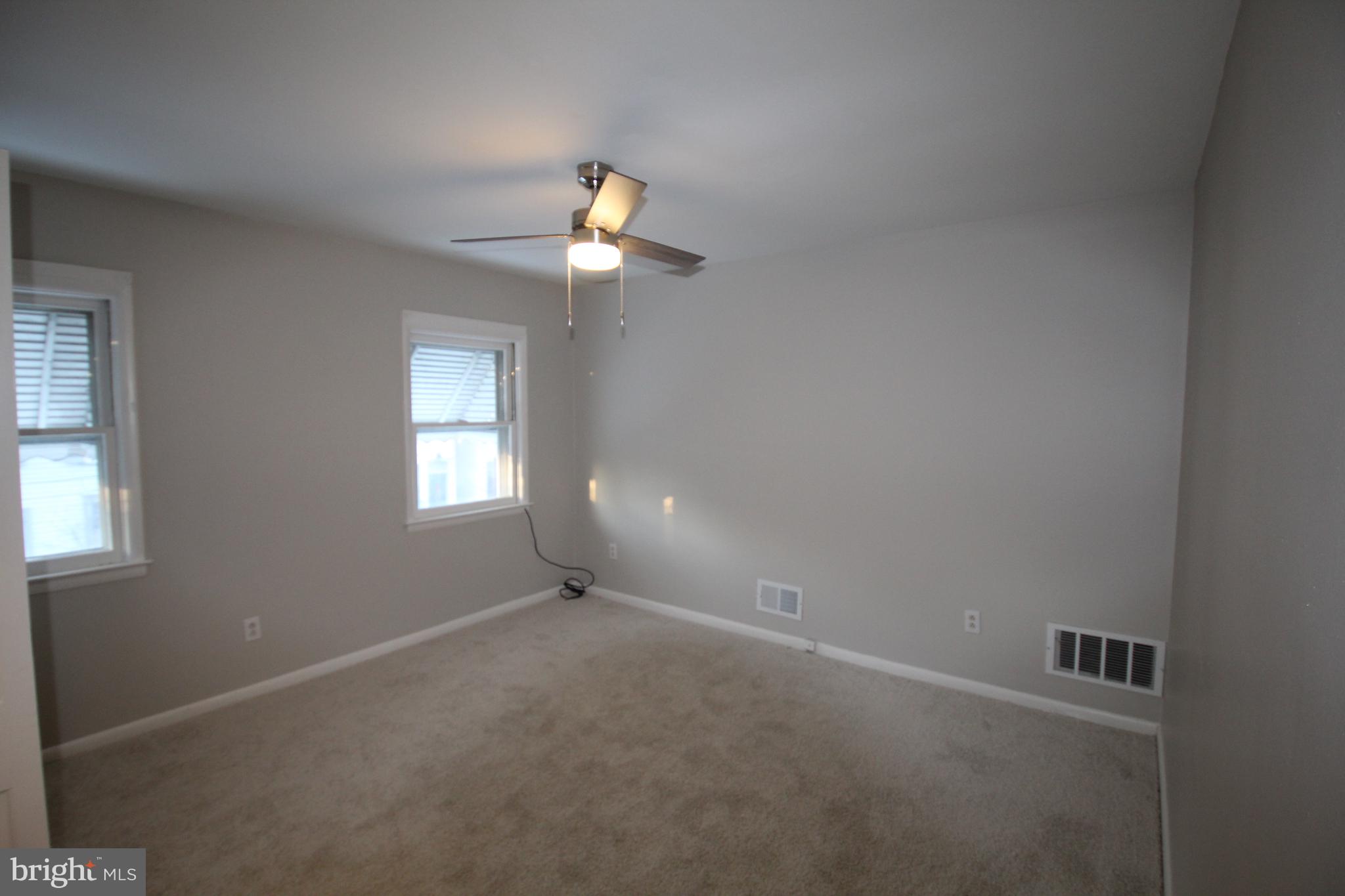 25 East 4th Street New Castle, DE 19720 - Photo 12 of 22 an empty room with windows and fan