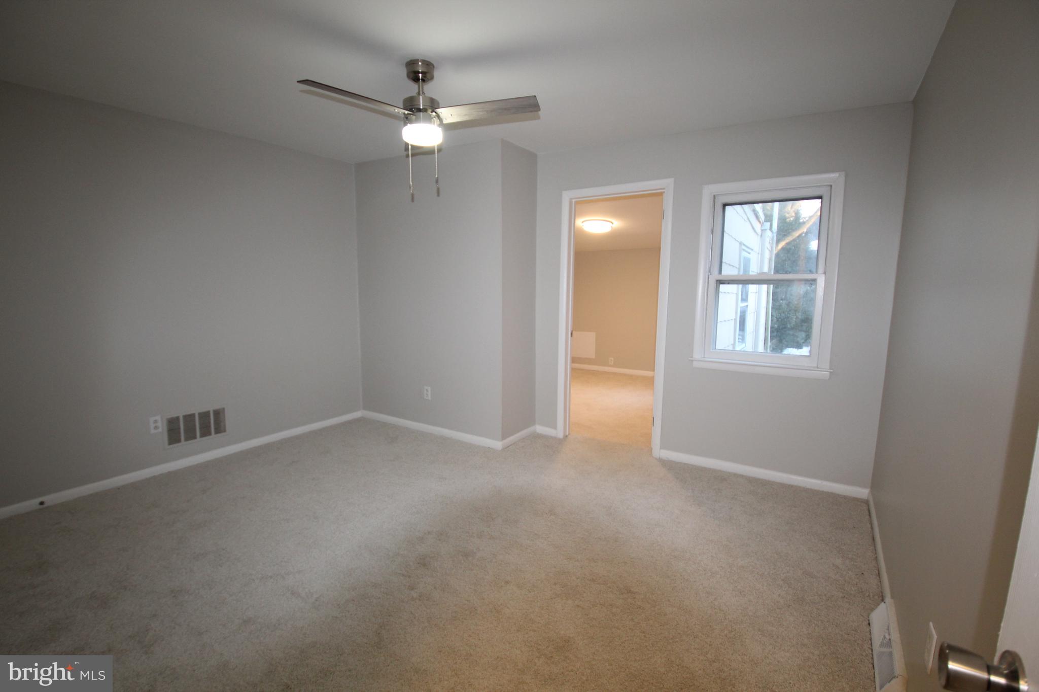25 East 4th Street New Castle, DE 19720 - Photo 15 of 22 an empty room with windows and fan
