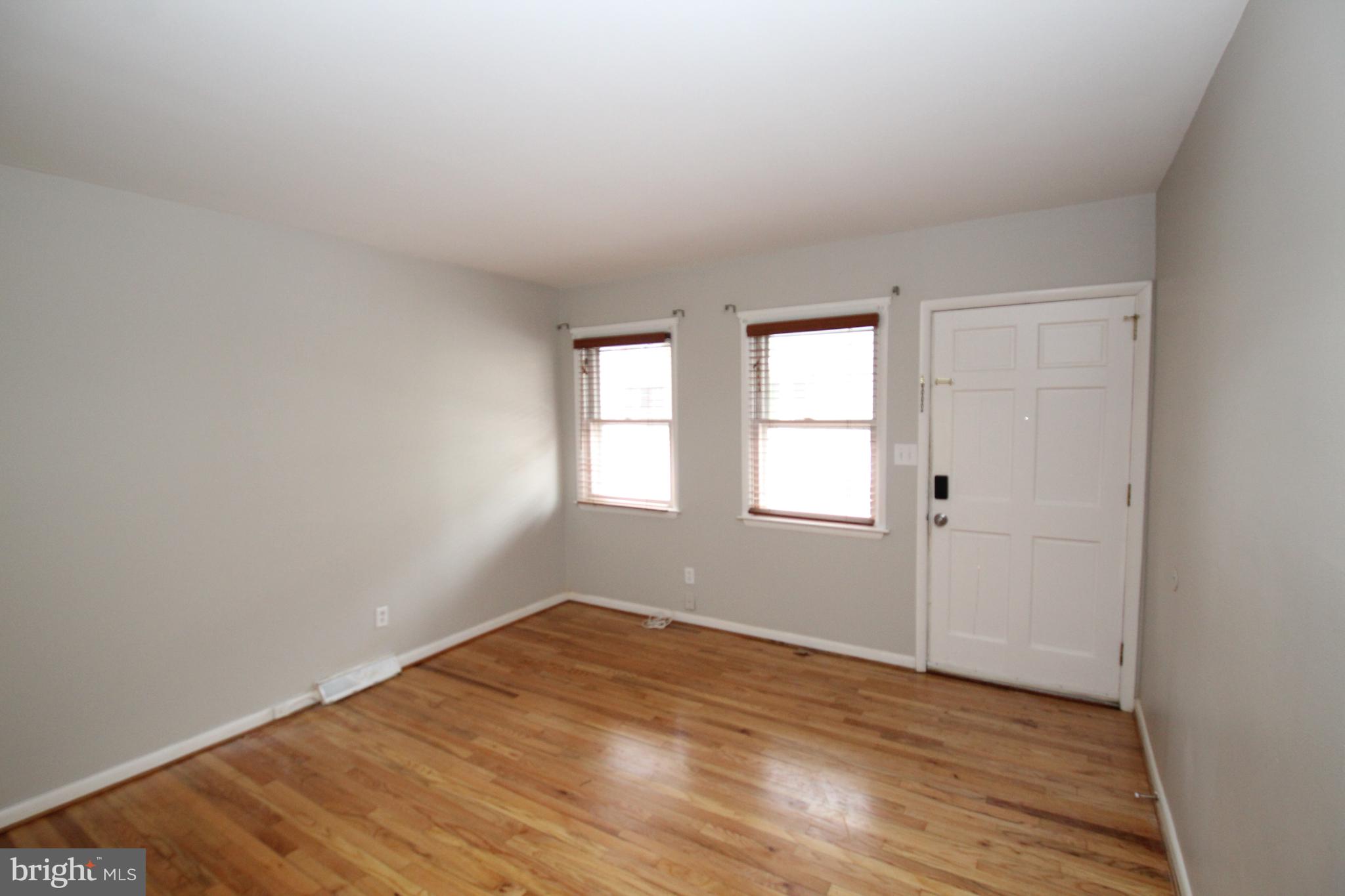25 East 4th Street New Castle, DE 19720 - Photo 2 of 22 an empty room with wooden floor and windows