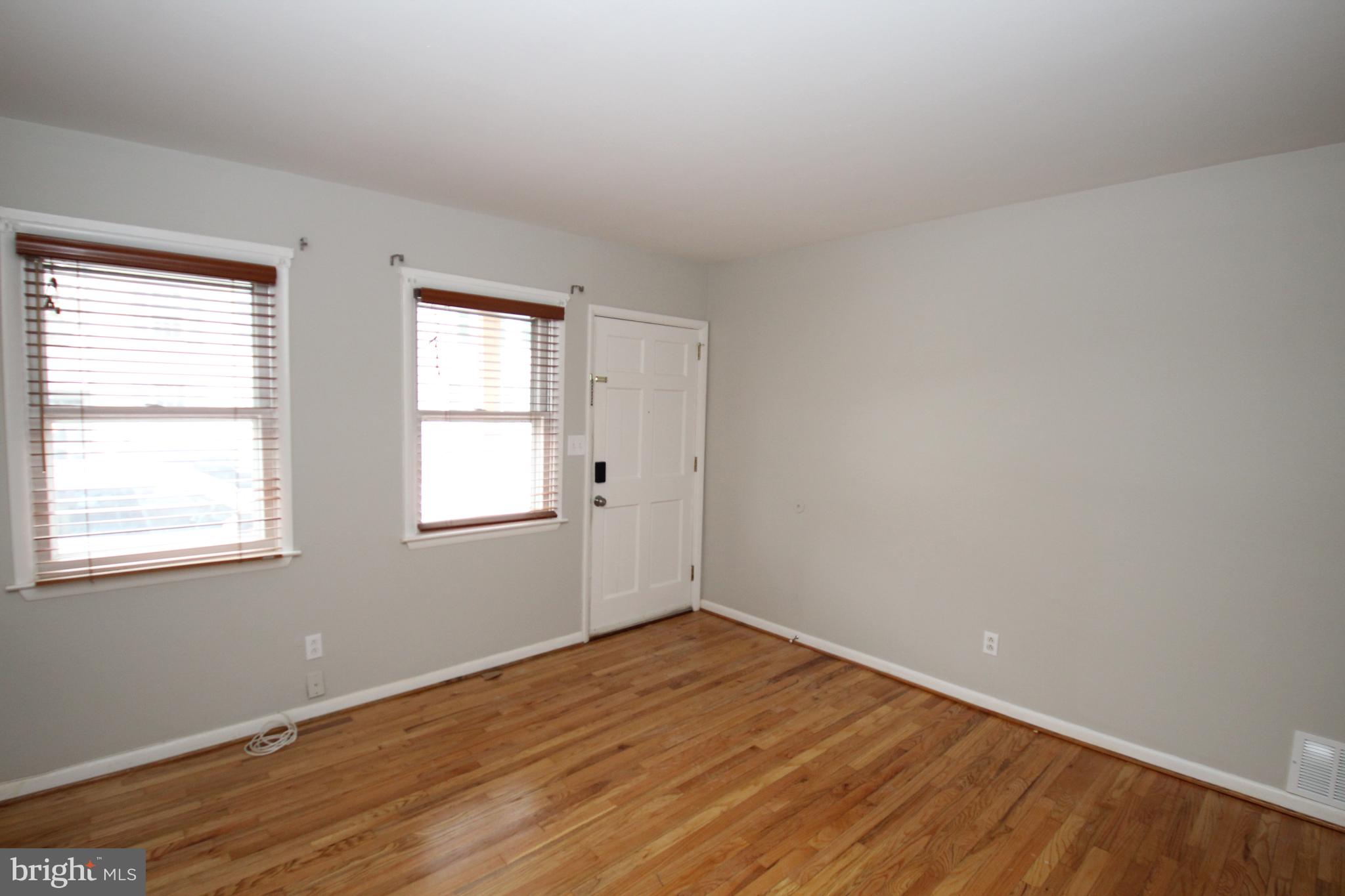 25 East 4th Street New Castle, DE 19720 - Photo 4 of 22 an empty room with wooden floor and windows