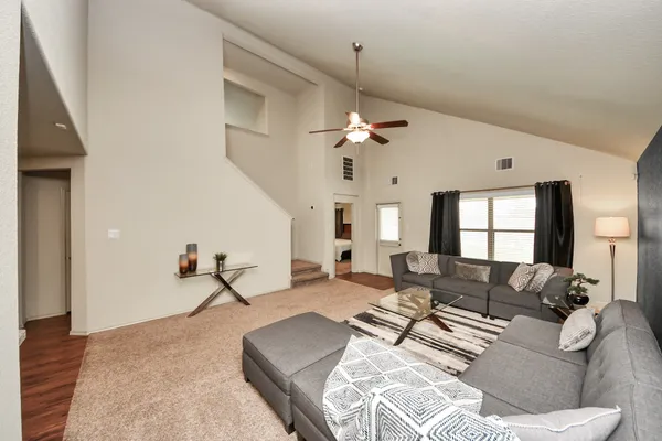 a living room with furniture and wooden floor
