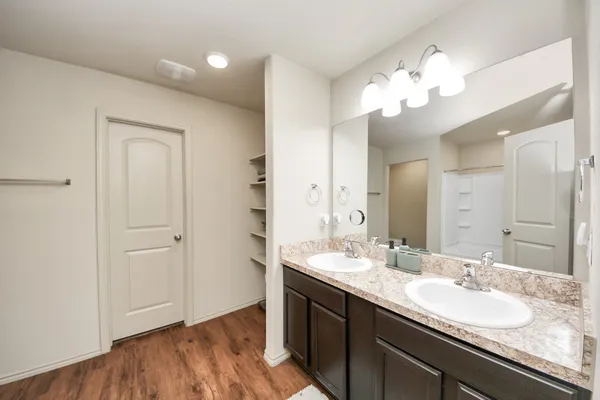 a bathroom with a double vanity sink and a mirror