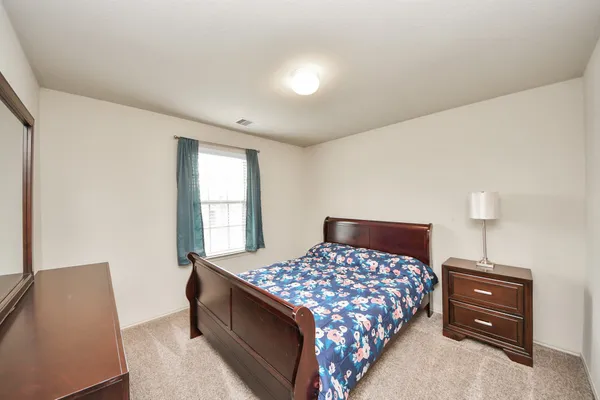 a bedroom with a bed and window