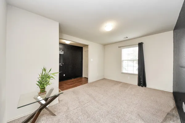 a view of an empty room and glass door