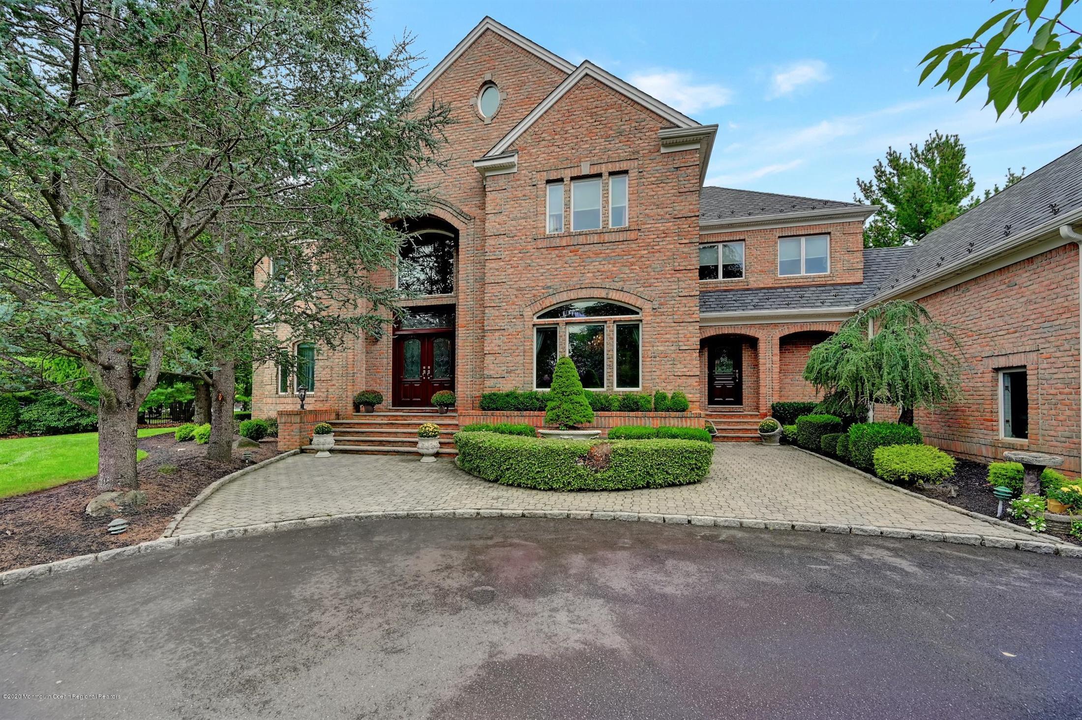 15 Rivers Edge Drive Colts Neck, NJ 07722 - Photo 1 of 1 a front view of a house with a yard and garage