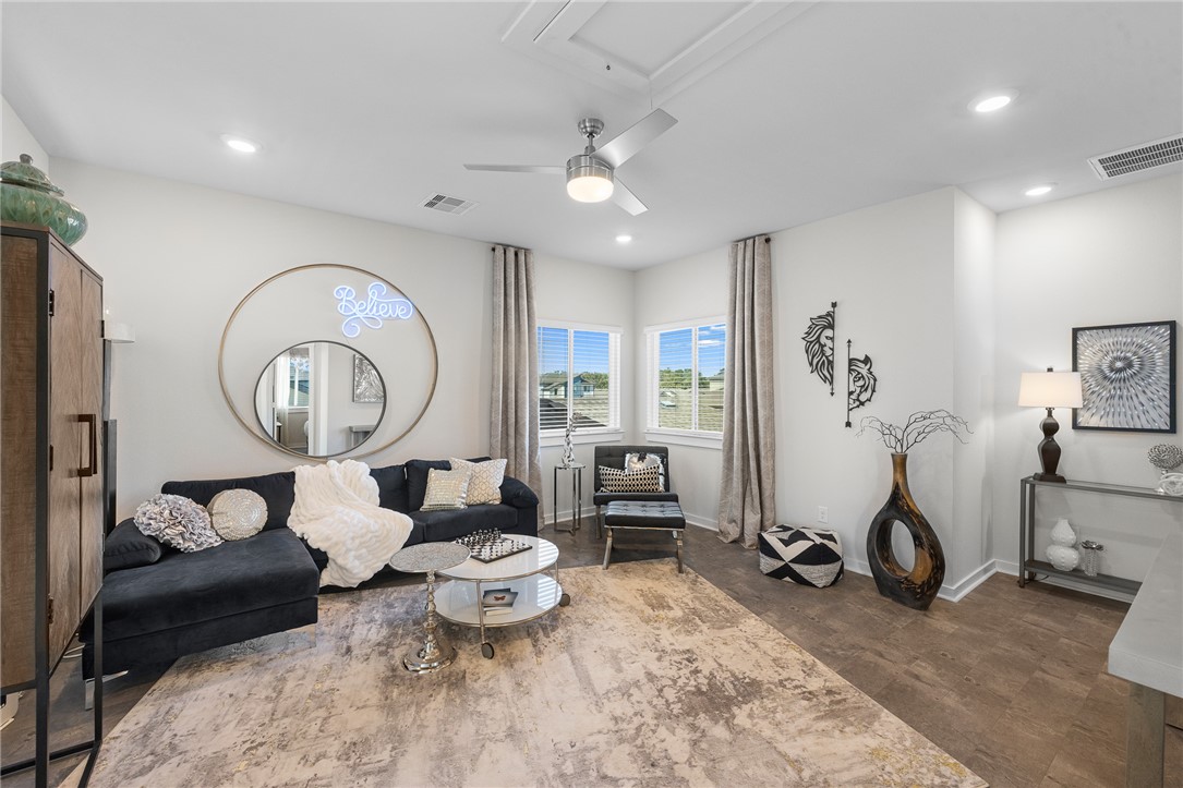 767 Double Mountain Road College Station, TX 77845 - Photo 11 of 34 a living room with furniture a clock and a large window