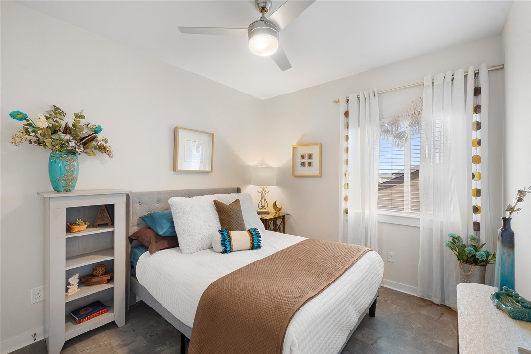 767 Double Mountain Road College Station, TX 77845 - Photo 20 of 34 a bedroom with a bed and a chandelier