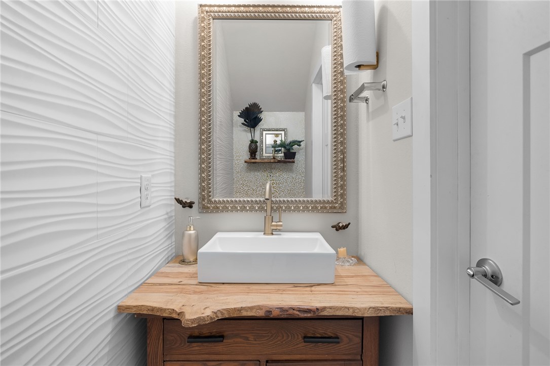 767 Double Mountain Road College Station, TX 77845 - Photo 3 of 34 a bathroom with a sink and a mirror