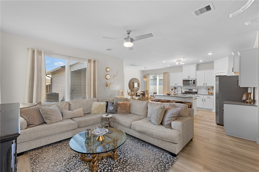 767 Double Mountain Road College Station, TX 77845 - Photo 6 of 34 a living room with furniture and a dining table with wooden floor
