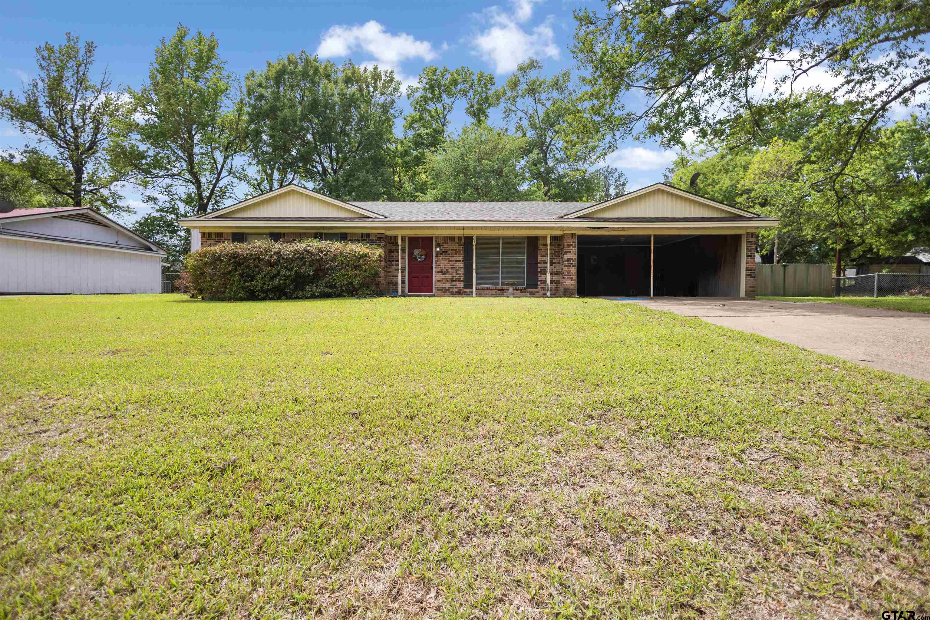 607 Beverly Drive Carthage, TX 75633 - Photo 3 of 11 a front view of a house with yard and trees