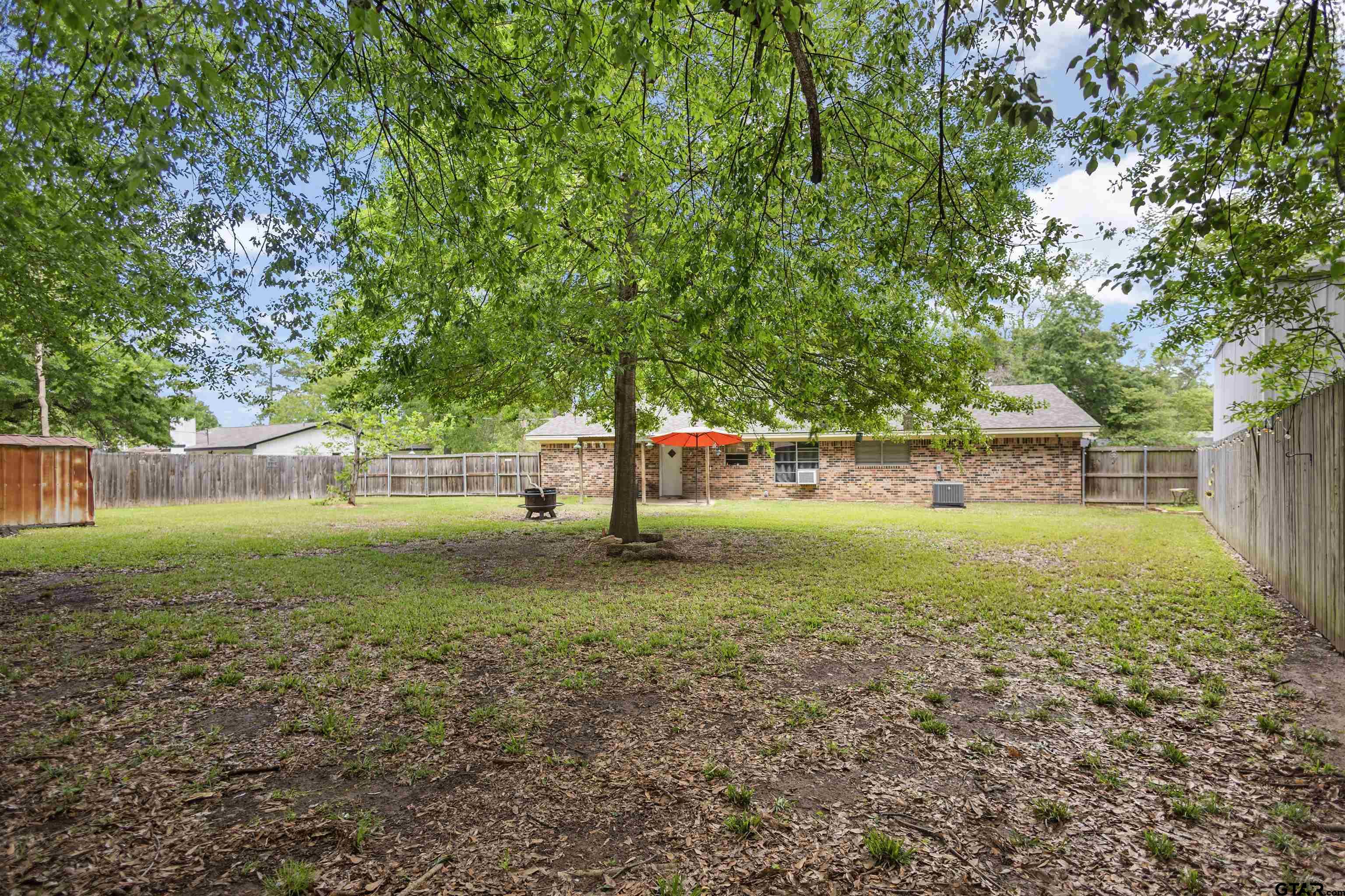 607 Beverly Drive Carthage, TX 75633 - Photo 4 of 11 a view of a yard with a tree