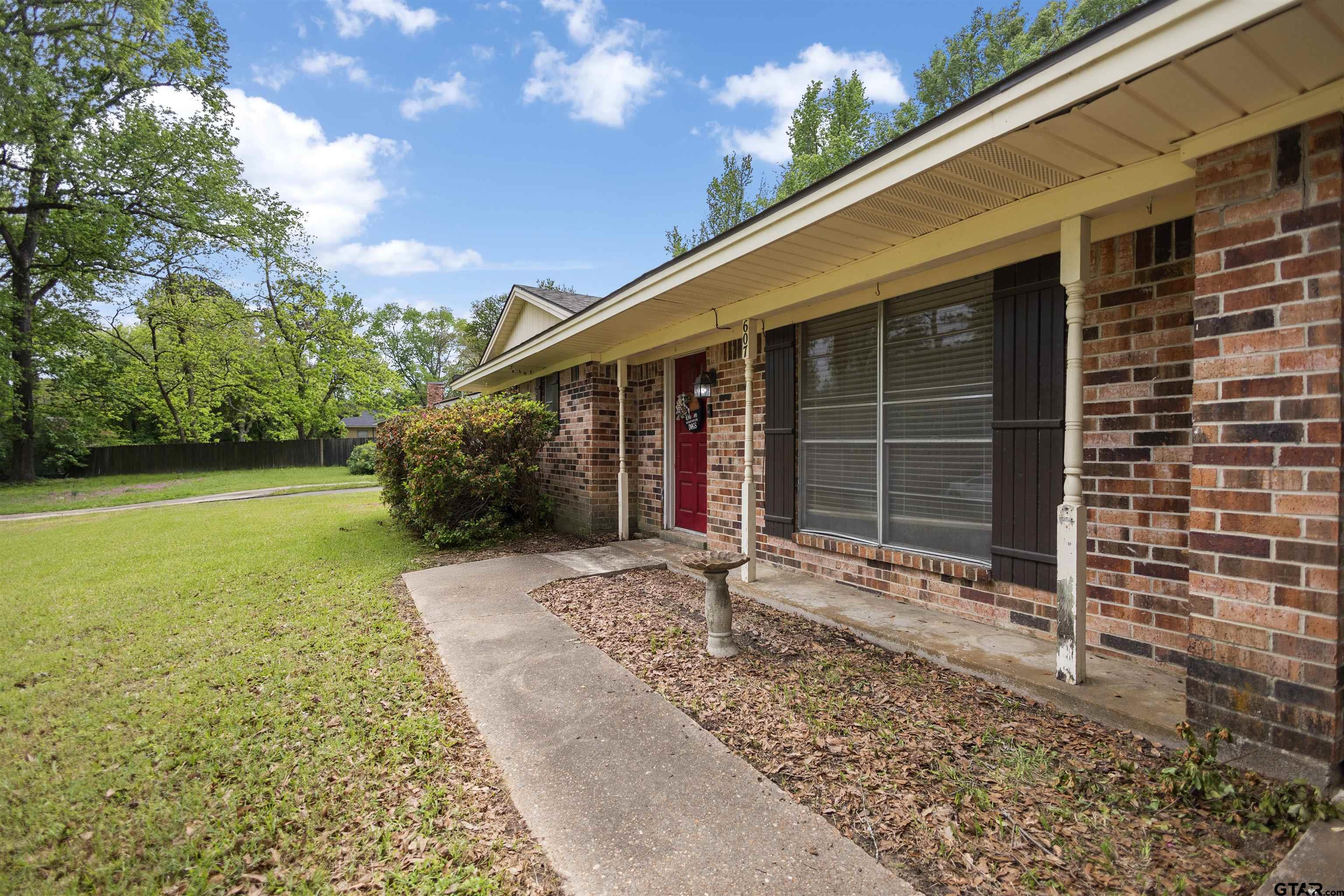 607 Beverly Drive Carthage, TX 75633 - Photo 8 of 11 a front view of a house with garden