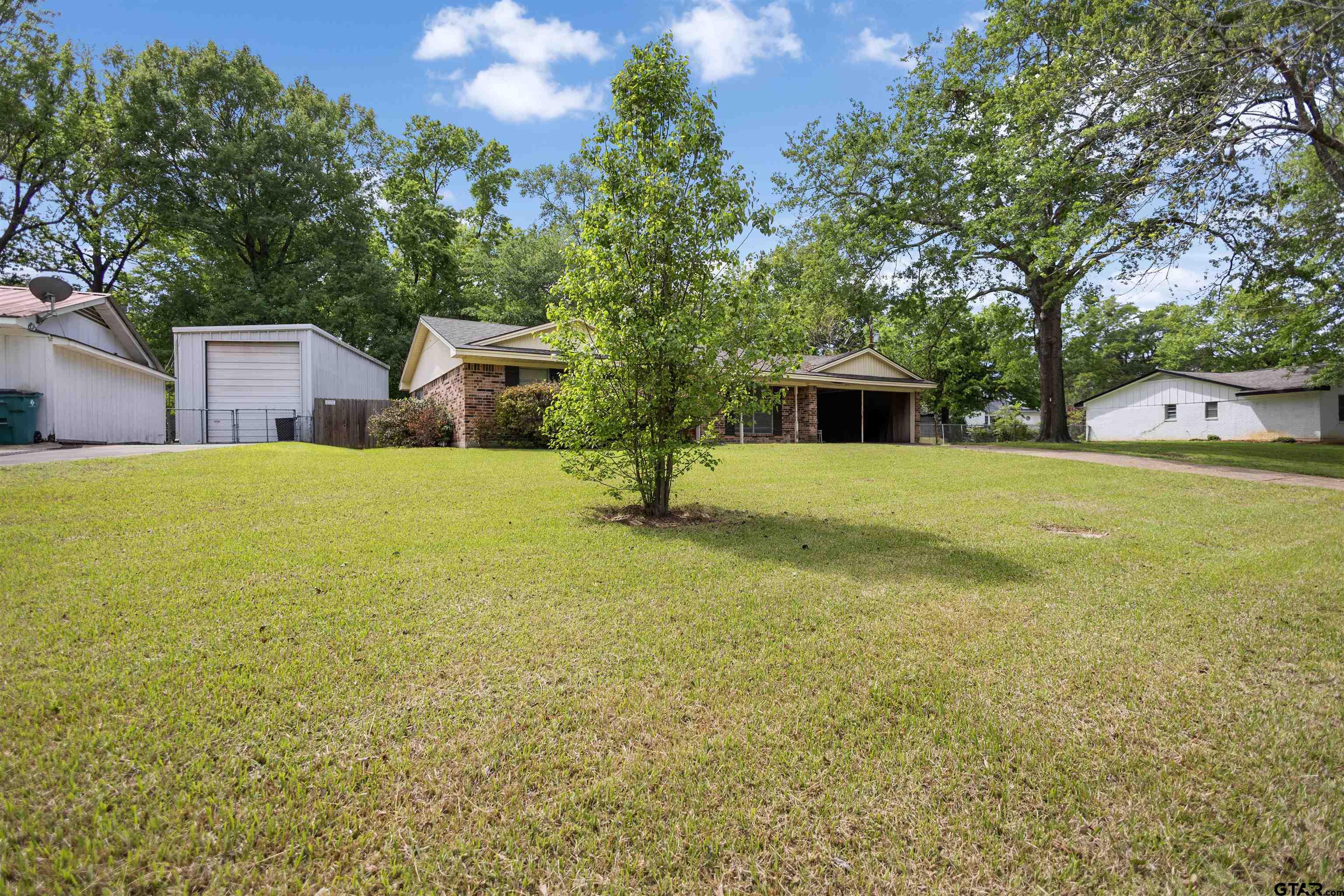 607 Beverly Drive Carthage, TX 75633 - Photo 9 of 11 a view of a house with yard and trees