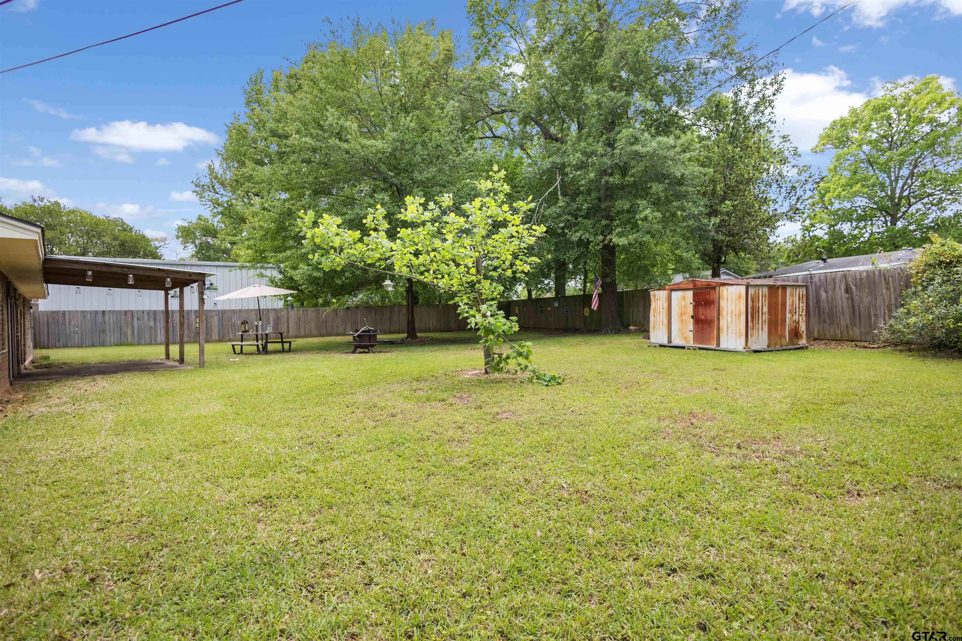 607 Beverly Drive Carthage, TX 75633 - Photo 10 of 11 a swimming pool with some trees in the background