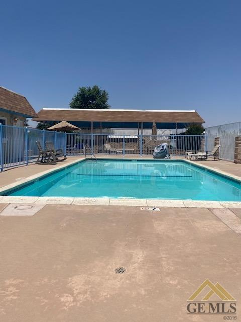 Undisclosed Address Bakersfield, CA 93307 - Photo 9 of 11 a view of a house with a yard and potted plants
