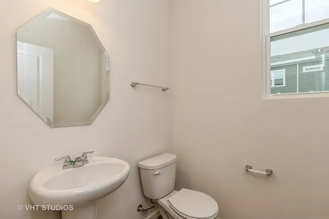 a bathroom with a sink mirror and toilet