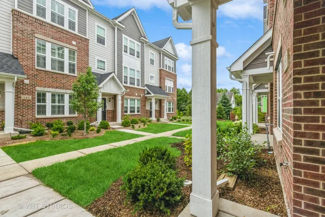 a view of a brick building next to a yard