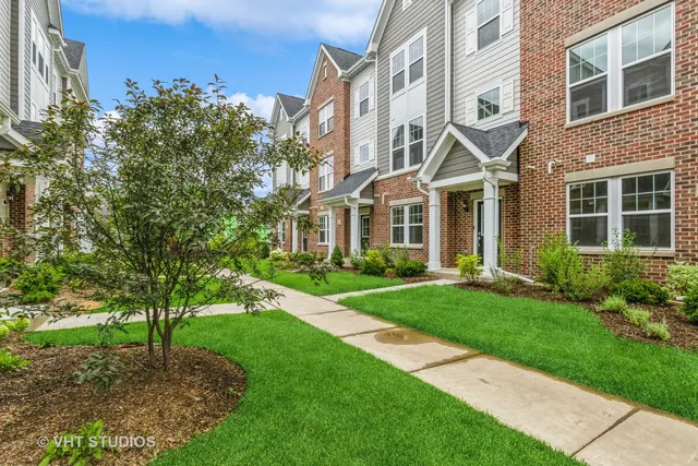 a view of a brick building next to a yard