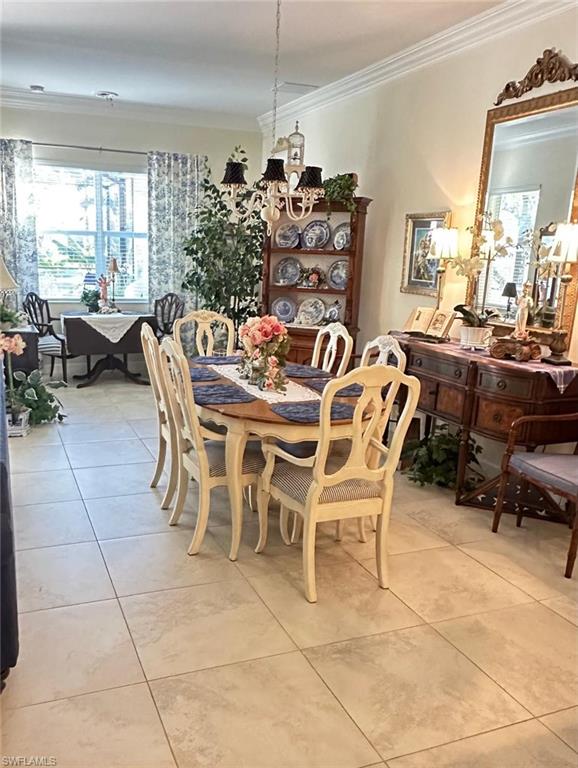 5220 Milano Street Ave Maria, FL 34142 - Photo 11 of 27 Dining space featuring crown molding, light tile patterned flooring, and a chandelier