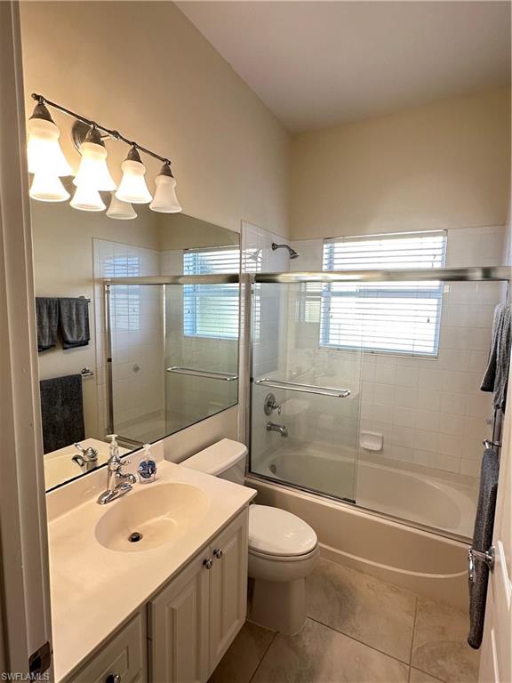 5220 Milano Street Ave Maria, FL 34142 - Photo 17 of 27 Full bathroom with vanity, combined bath / shower with glass door, and light tile patterned floors