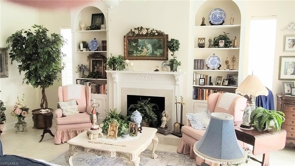 5220 Milano Street Ave Maria, FL 34142 - Photo 6 of 27 Sitting room featuring built in shelves and a fireplace