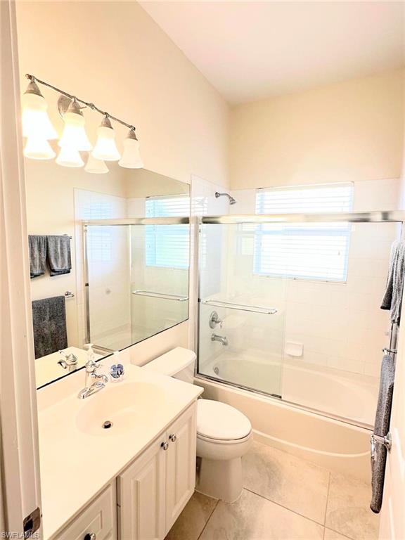 5220 Milano Street Ave Maria, FL 34142 - Photo 7 of 27 Full bath with vanity, shower / bath combination with glass door, and light tile patterned floors
