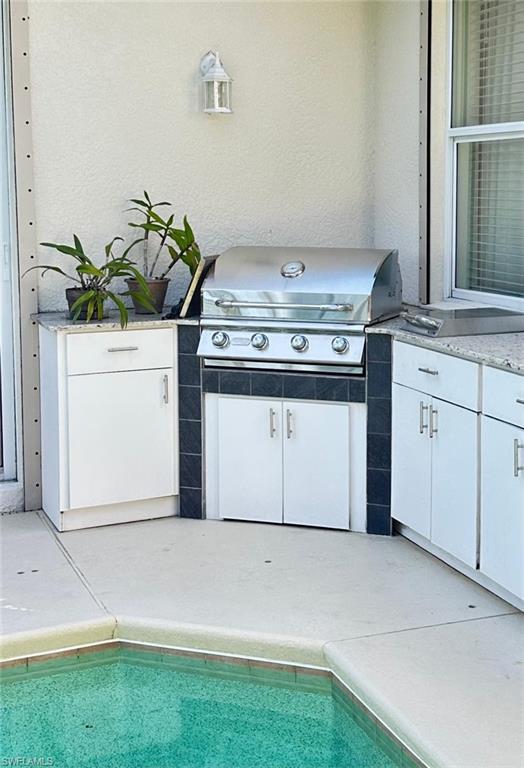 5220 Milano Street Ave Maria, FL 34142 - Photo 10 of 27 View of patio / terrace featuring an outdoor kitchen and an outdoor pool