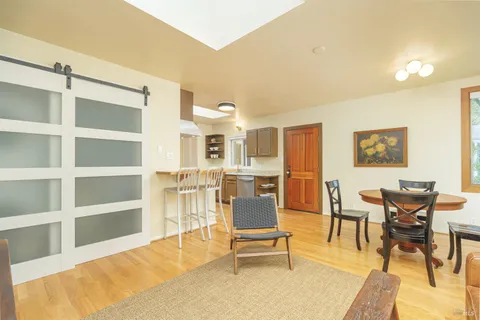 a living room with furniture a rug and kitchen view