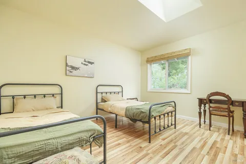a bedroom with two beds and a desk