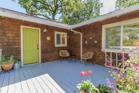 a backyard of a house with wooden floor yard and outdoor seating