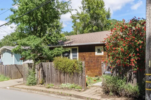 a front view of a house with a garden