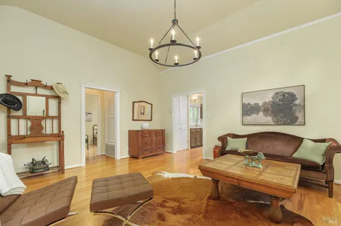 a living room with furniture a rug and wall paintings