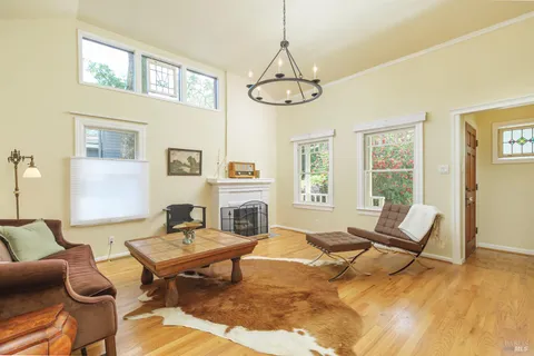 a living room with furniture a fireplace and a table