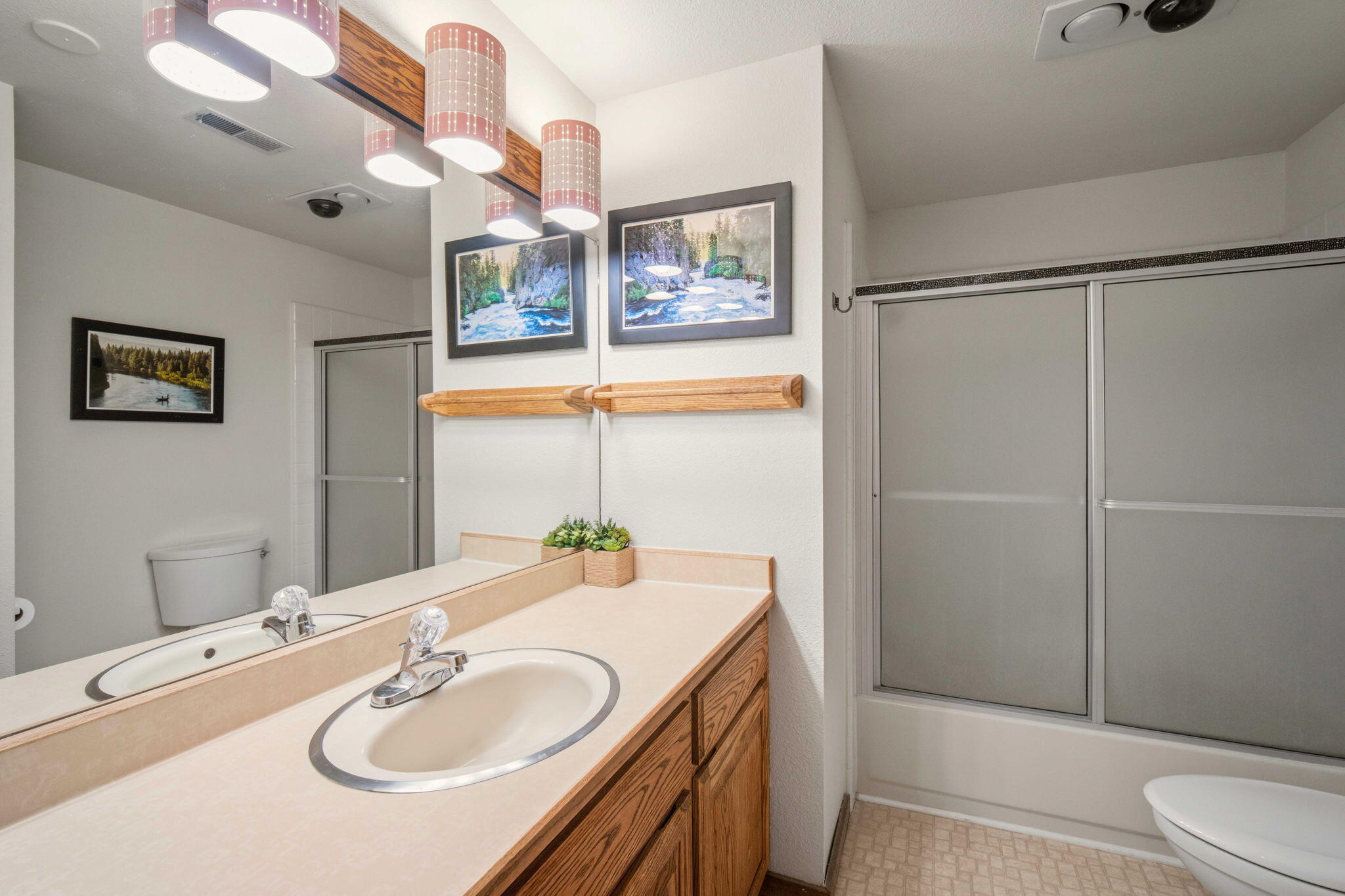 57305 Beaver Ridge Loop, Unit 8 Sunriver, OR 97707 - Photo 17 of 25 a bathroom with a sink a toilet and shower