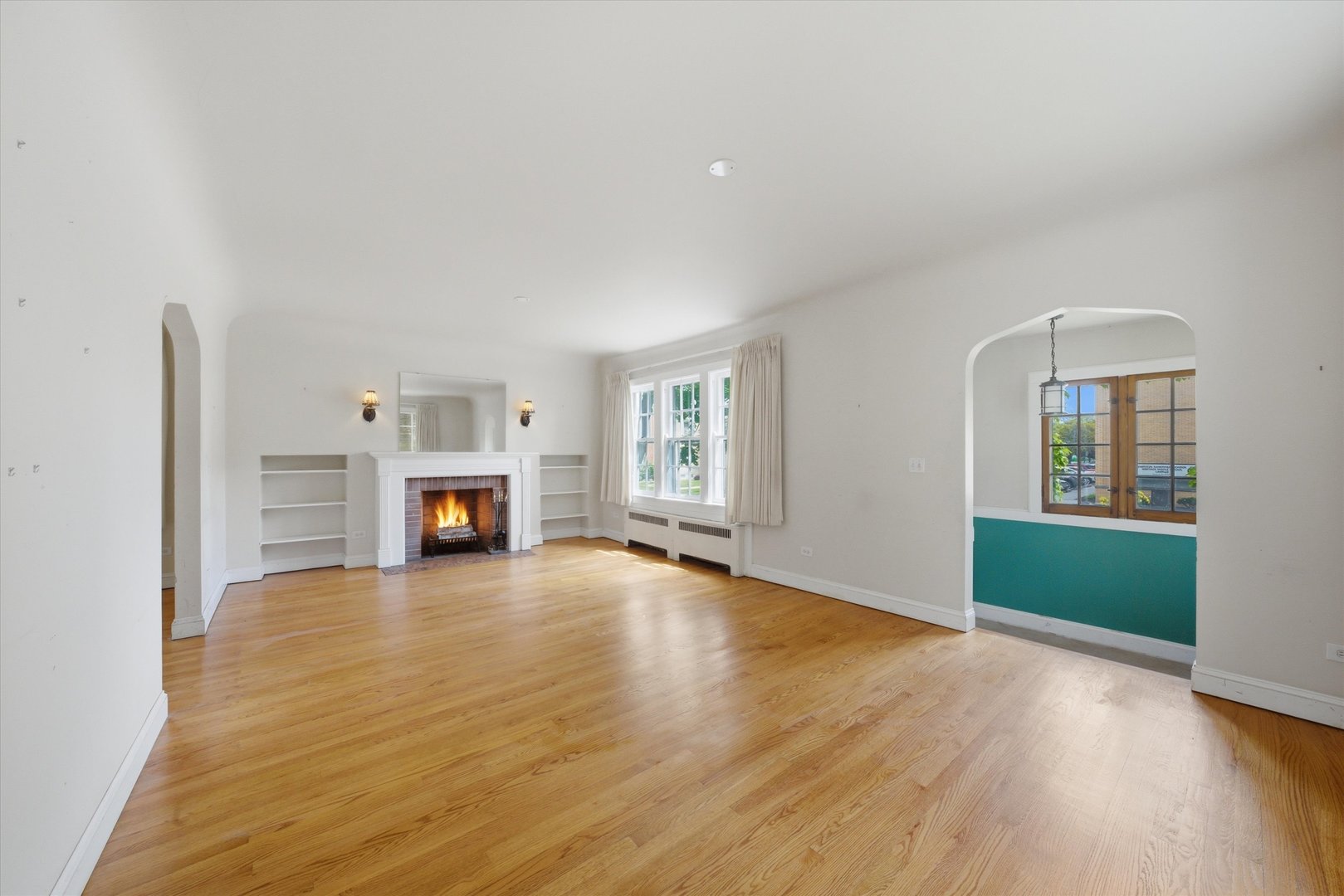 3100 Clinton Avenue Berwyn, IL 60402 - Photo 3 of 25 an empty room with fireplace and windows