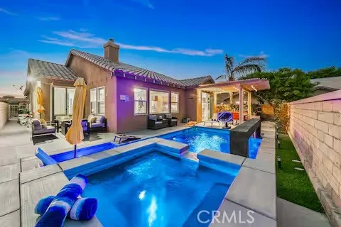 a view of a patio with table and chairs and potted plants