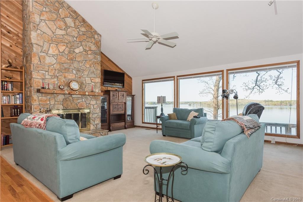 29040 Snapper Point Tega Cay, SC 29708 - Photo 3 of 39 a living room with fireplace furniture and a large window