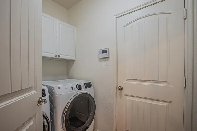 a view of storage and utility room with washer and dryer