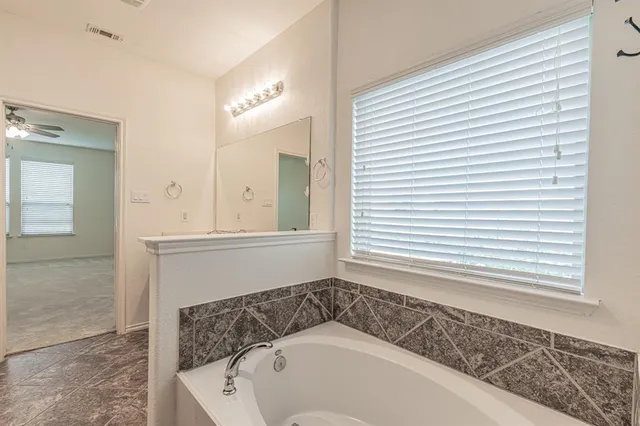 a bathroom with a bathtub and a sink