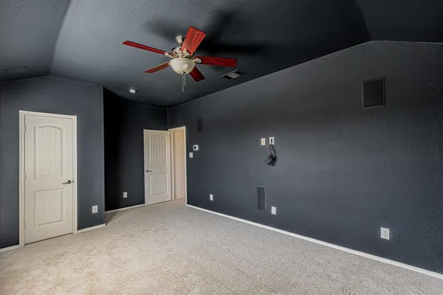 a view of a livingroom with a ceiling fan and window